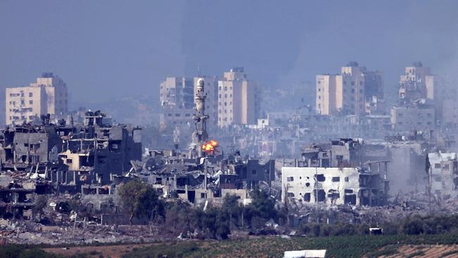 A missile strikes behind a minaret in Gaza on Saturday. Picture: Dan Kitwood/Getty Images