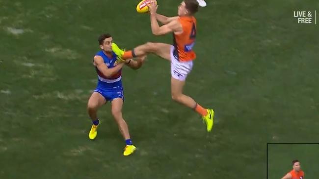 Toby Greene fends off Luke Dahlhaus with a boot in the face.