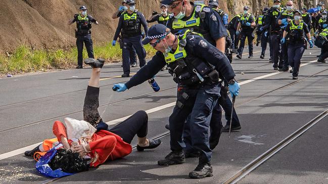 The elderly female protester was pushed violently to the ground and then hit with pepper spray. Picture: Jason Edwards