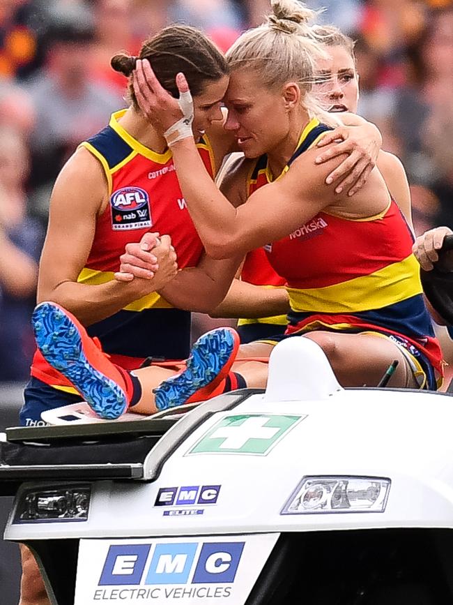 Chelsea Randall supports Erin Phillips as she is driven from Adelaide Oval after tearing her ACL during the Crows’ AFLW grand final win in March. Picture: Daniel Kalisz/Getty Images