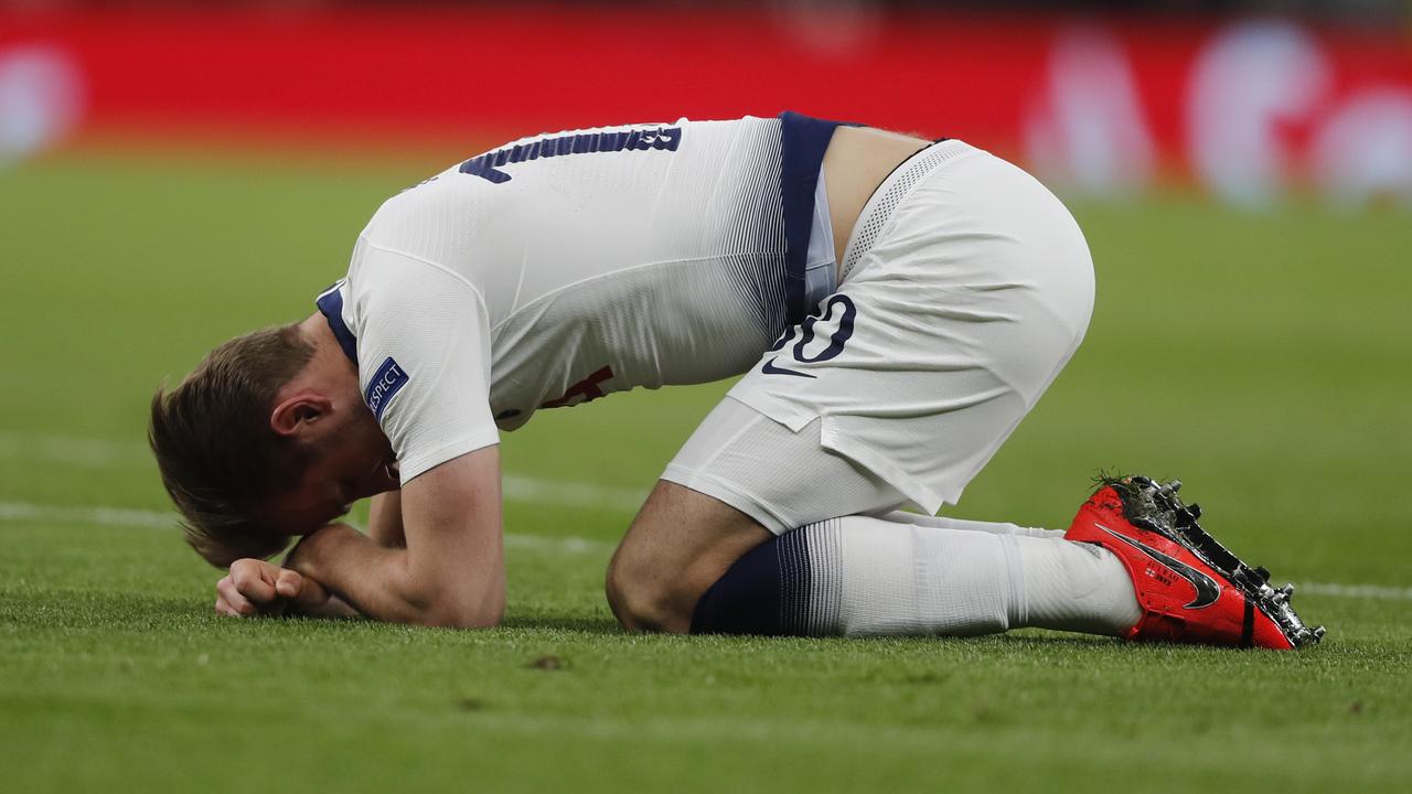 Harry Kane lies on the pitch after being taken out by Fabian Delph