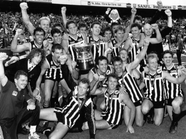 SANFL Football - Glenelg vs Port Adelaide Grand Final match at Football Park 6 Oct 1990. Port Adelaide footballers with Premiership trophy after winning match.