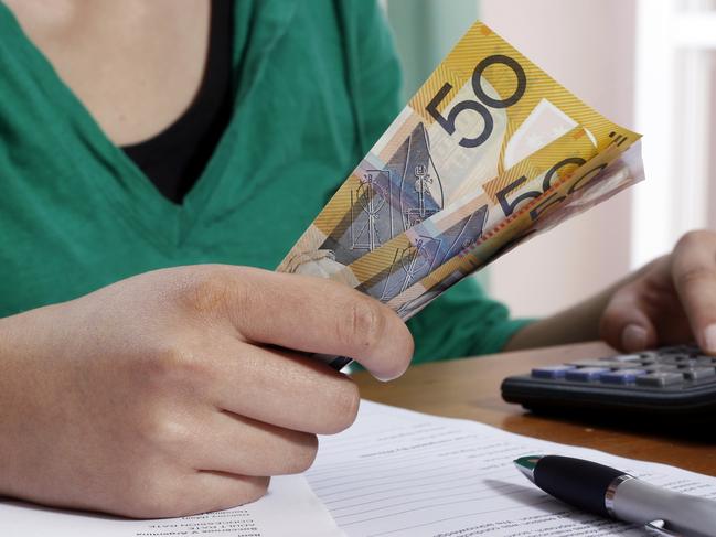 MoneysaverHQ - a woman holding Australian money.  cash / budget. Picture: iStock