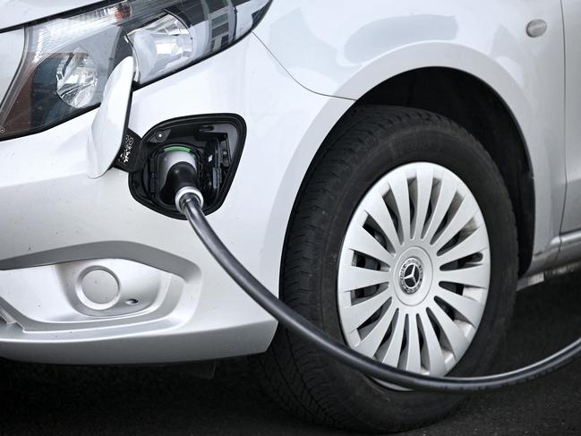 A charging connector is pictured charging a vehicle at Gridserve E-charging station for all-electric cars, near Braintree, eastern England on August 8, 2023. (Photo by Justin TALLIS / AFP)