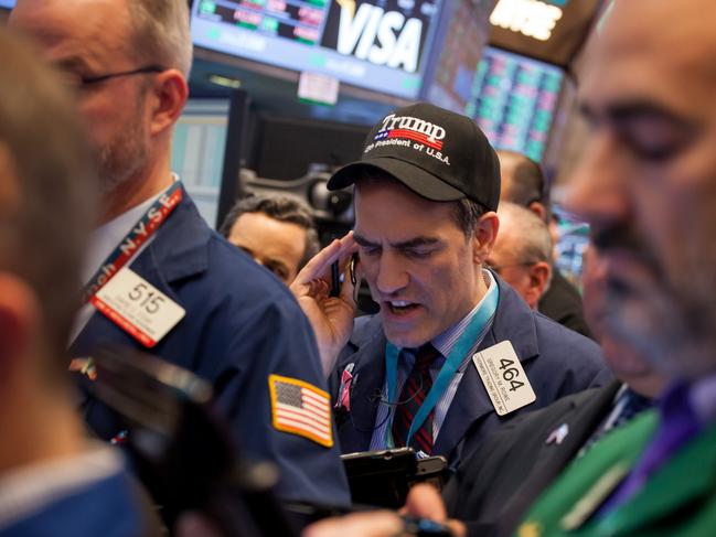 A trader wears a hat displaying the name of U.S. President Donald Trump while working on the floor of the New York Stock Exchange (NYSE) in New York, U.S., on Friday, Jan. 20, 2017. U.S. stocks rose as an increase in crude oil spurred gains in energy companies, while investors await Donald Trump’s inauguration as the nation’s 45th president. Consumer staples shares climbed as Procter & Gamble Co. reported quarterly earnings that topped estimates. Photographer: Michael Nagle/Bloomberg