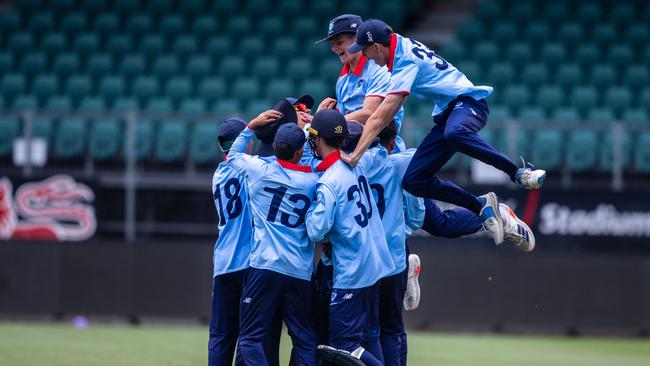 NSW Metro players celebrate taking the match sealing wicket against Queensland in the under-17 national cricket championships final at Launceston on Thursday. Picture: Linda Higginson/Cricket Australia (EDITORIAL USE ONLY)