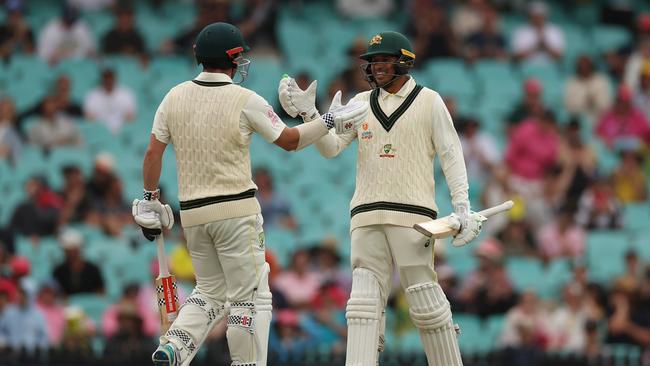 Travis Head (l) celebrates reaching his half century with Usman Khawaja. Picture: Getty