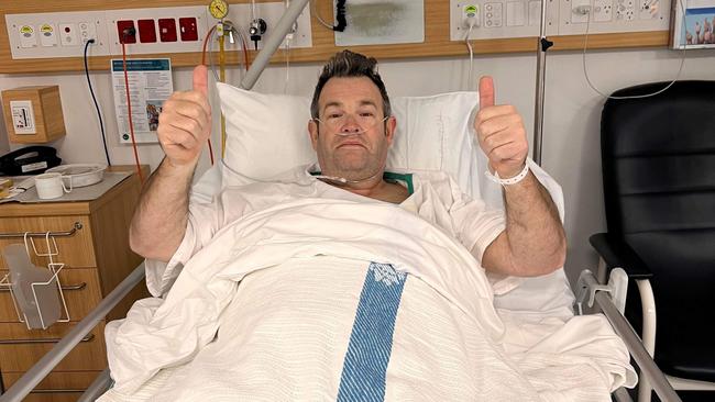 Beloved presenter Gus Worland gives the thumbs-up post-hernia operation.