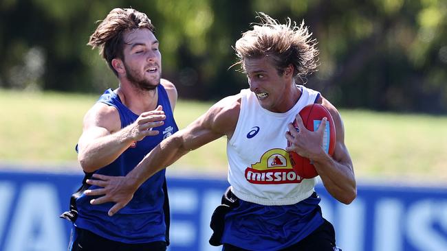 Rhylee West attempts to chase down Roarke Smith at training on Monday. Picture: Michael Klein