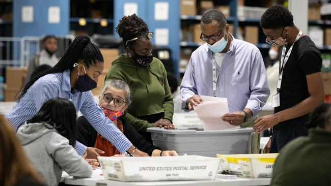 Election workers assess absentee and provisional ballots at the Voter Registrations and Elections office in Gwinnett, Georgia. Picture: Getty Images/AFP