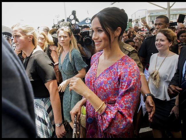 Meghan with a female Police Protection officer and Fijian security officers as she visits Suva Market in 2018. Picture: i-Images / Pool