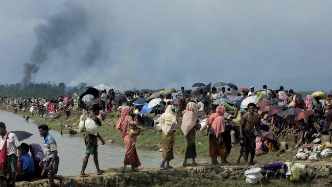 Smoke billows from a burning village as thousands of Rohingya flee their homes. Picture: K.M. Asad