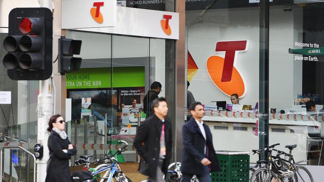 A Telstra logo is seen as pedestrians walk outside the Telstra Melbourne headquarters in Melbourne: Picture: Getty