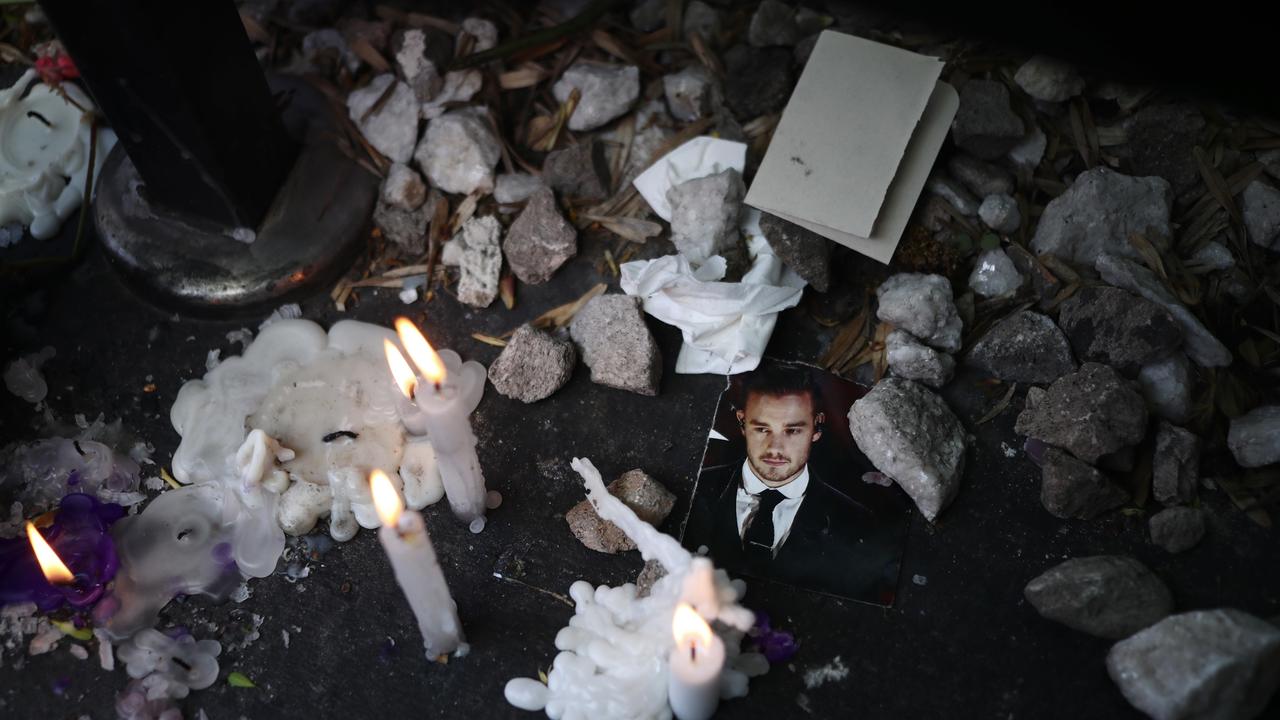 A photo of One Direction star Liam Payne sits surrounded by candle tributes. Picture: Marcos Brindicci/Getty Images