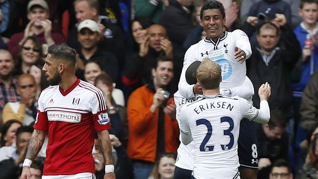 Tottenham Hotspur's Paulinho, right top, celebrates his goal against Fulham with teammates.