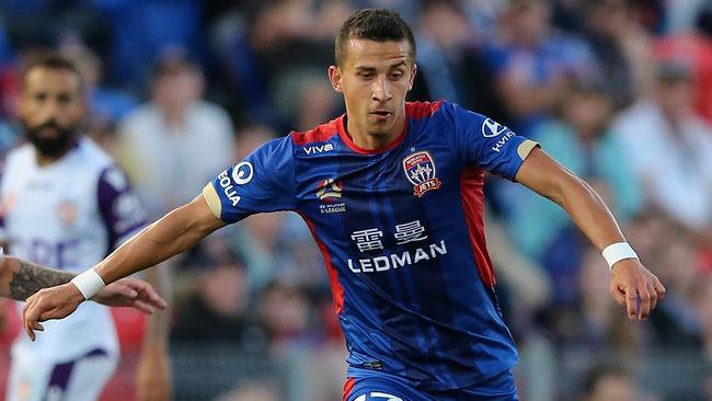 NEWCASTLE, AUSTRALIA — OCTOBER 15: Daniel Georgievski of the Jets is contested by the Glory defence during the round two A-League match between the Newcastle Jets and Perth Glory at McDonald Jones Stadium on October 15, 2017 in Newcastle, Australia. (Photo by Ashley Feder/Getty Images)