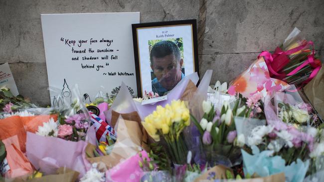 Floral tributes and a photograph of PC Keith Palmer lay outside the Houses of Parliament. Picture: Getty