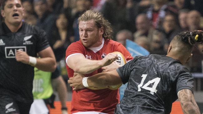 Dan Moor of Canada tries to break free from Sean Wainui of the Maori All Blacks.