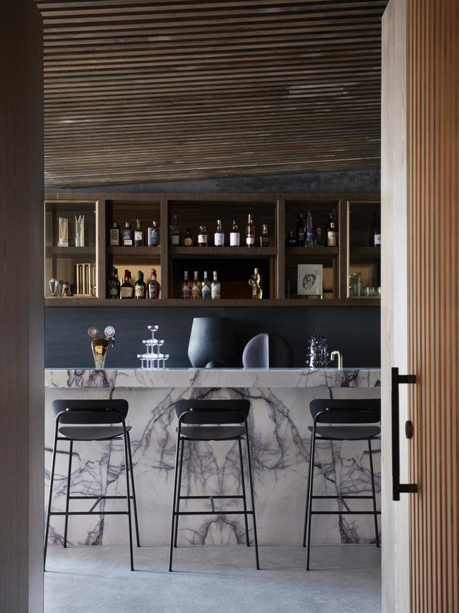 The walnut-stained ceiling runs through the man cave.