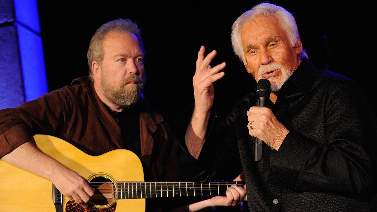 (L-R) Songwriter Don Schlitz and country music legend Kenny Rogers perform at the Country Music Hall Of Fame in Nashville, Tennessee. Picture: Getty Images