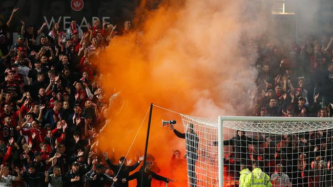 SYDNEY, AUSTRALIA - APRIL 25: A flare is lit amongst Wanderers fans during the round 27 A-League match between the Western Sydney Wanderers and the Perth Glory at Pirtek Stadium on April 25, 2015 in Sydney, Australia. (Photo by Brendon Thorne/Getty Images)