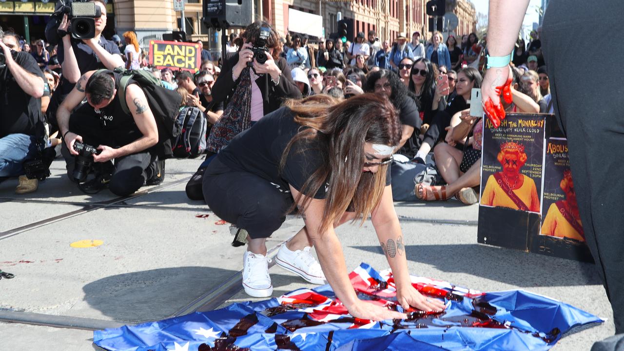 The politician dipped her hand in red paint and wiped it on an Australian flag. Picture: NCA NewsWire / David Crosling