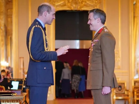 Prince William put on a brave face as he made Brigadier Tobias Lambert an OBE. Picture: PA.