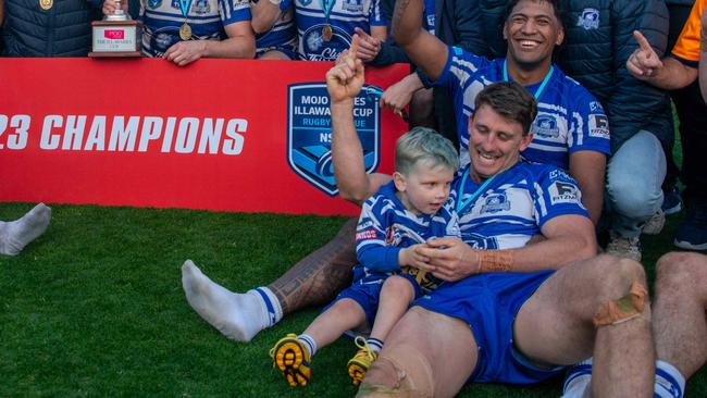 Job well done. Bremner celebrates a premiership with his son. Picture: Thomas Lisson.