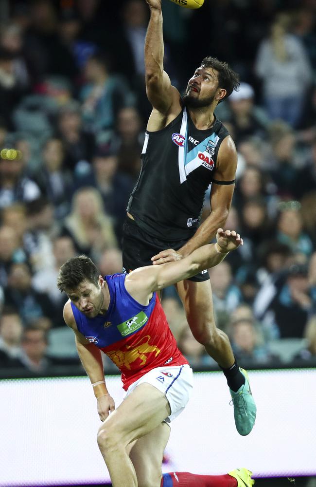 Port Adelaide’s Paddy Ryder soars above Brisbane Lions’ Stefan Martin. Picture: SARAH REED