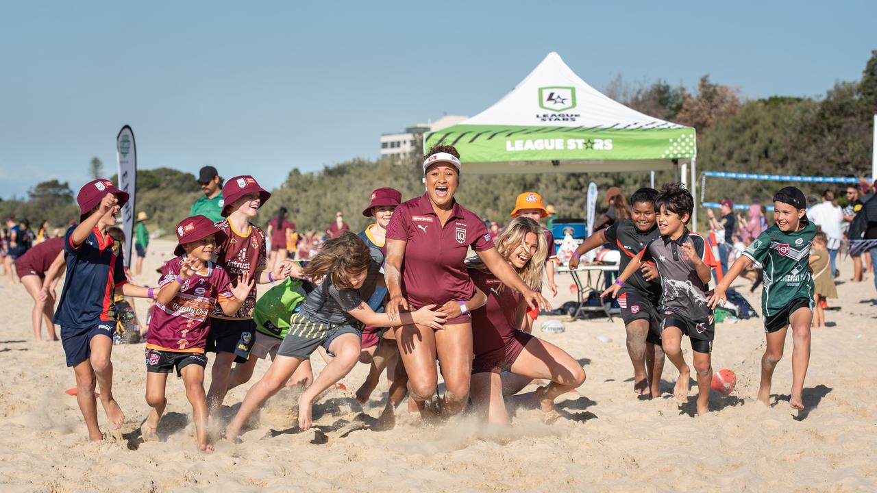 Queensland State of Origin players Shania Power and Julia Robinson are tackled by fans on Mooloolaba Beach on the Sunshine Coast. PICTURE: Brad Fleet