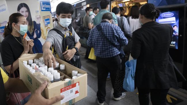 Commuters take cleaning gel for hands during a campaign for washing hands at the skytrain station in Bangkok. Picture: AP