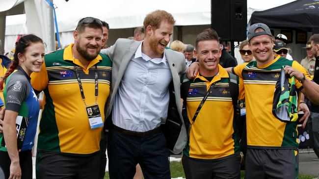 Prince Harry having a laugh with some Aussie athletes. Picture: Jonathan Ng