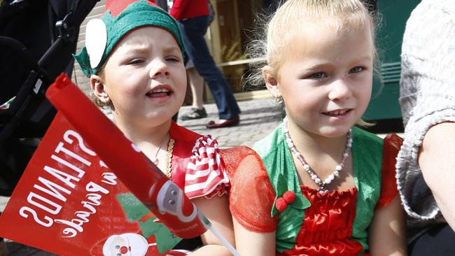 Sisters Jaynah, left, 4, and Indii, 5, Ford in the front row at the Eastlands Christmas Parade. Picture: KIM EISZELE