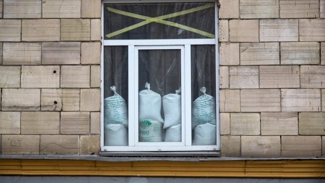 A window is protected with tape and sandbags against gun fire and explosions  in Kyiv, Ukraine. Picture: Pierre Crom/Getty Images