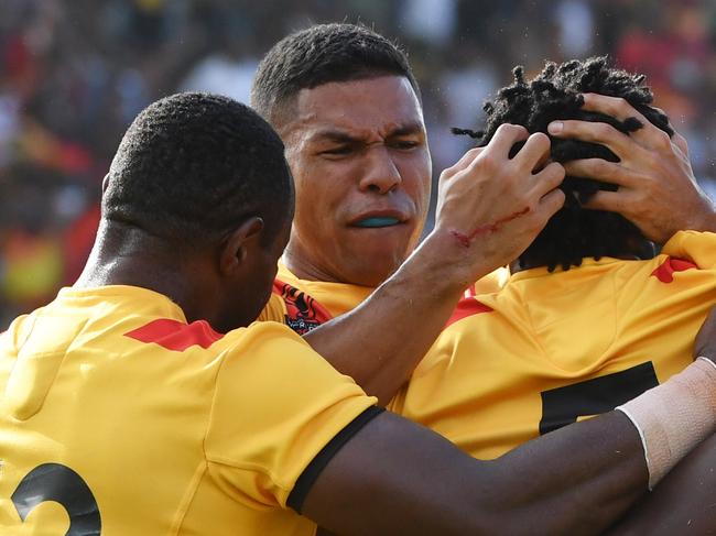 Papua New Guine players celebrate after Gary Lo (C) scored a try during the Rugby League World Cup match with Ireland Wolfhounds at the National Football Stadium in Port Moresby, Papua New Guinea, Sunday, November 5, 2017. (AAP Image/Mick Tsikas) NO ARCHIVING, EDITORIAL USE ONLY