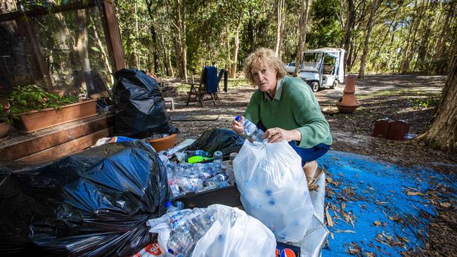 Couran Cove resident Rhonda Dalgleish sorting through recycling. All services have been cut off to the island. Picture: Nigel Hallett