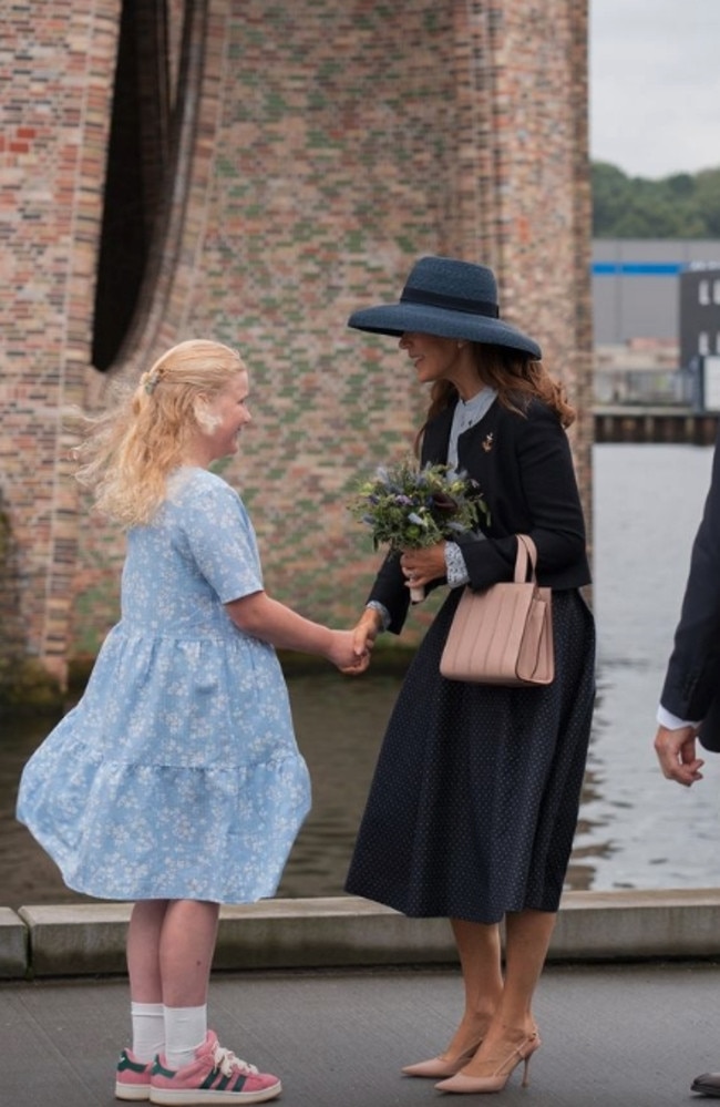 Queen Mary greets a young girl that presented her with flowers. Picture: Instagram