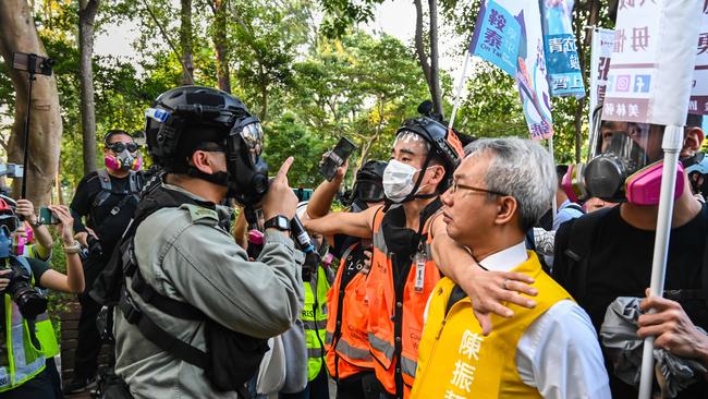 Richard Chan, a candidate for the district council elections, stares down officers as riot police clear the Victory park area on November 2.