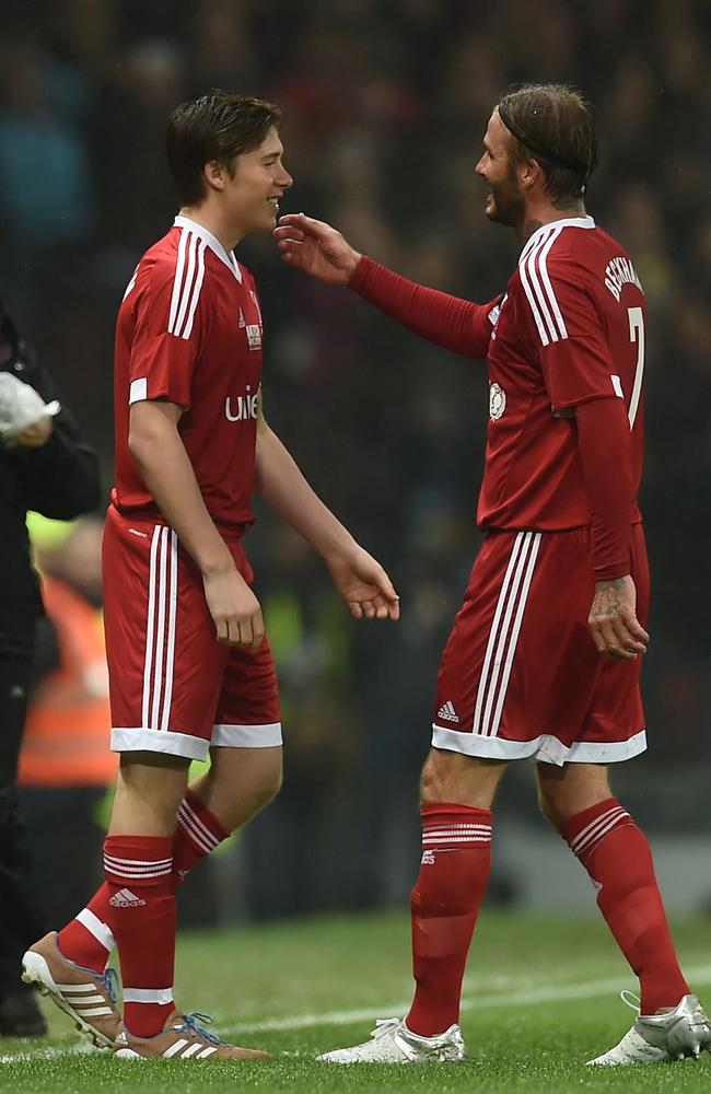 GB and Ireland’s English captain David Beckham is substituted for his son Brooklyn during a charity football match between a Great Britain and Ireland team and a Rest of the World team at Old Trafford in Manchester, on November 14, 2015 in aid of UNICEF. Picture: AFP