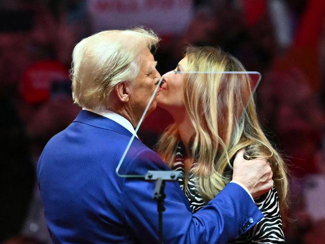 Former US President and Republican presidential candidate Donald Trump kisses former First Lady Melania Trump on stage during a campaign at Madison Square Garden in New York, October 27, 2024. (Photo by ANGELA WEISS / AFP)