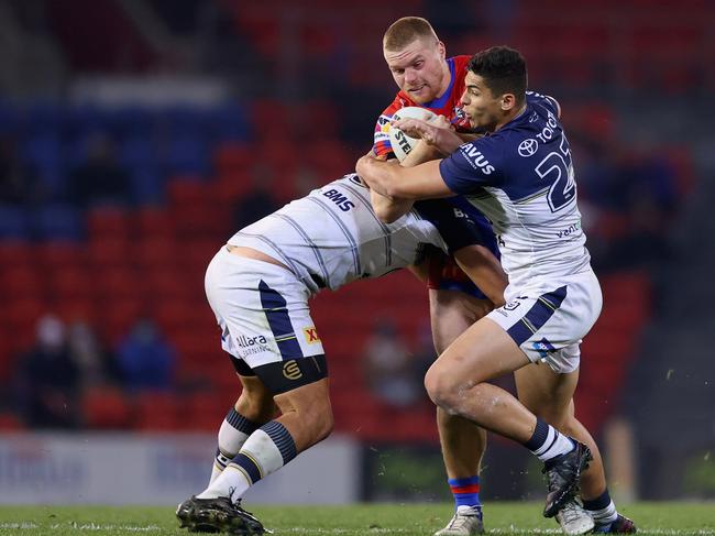 Josh King of the Knights is tackled during the round 16 NRL match between the Newcastle Knights and the North Queensland Cowboys at McDonald Jones Stadium.