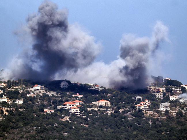 A cloud of smoke erupts during an Israeli air strike on the village of Sujud in southern Lebanon on September 25, 2024. Israel announced dozens of new air strikes on Hezbollah strongholds in Lebanon on September 24, a day after 492 people, including 35 children, were killed in the deadliest bombardment since a devastating war in 2006. (Photo by Rabih DAHER / AFP)