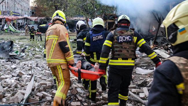 Rescuers carrying a wounded person from a hotel in the city of Cherkasy after an overnight missile attack. Picture: AFP