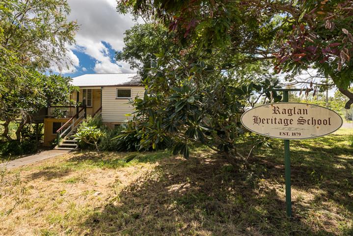 This Raglan Heritage School, built in 1879, and a three-bedroom, high set home are for sale. 