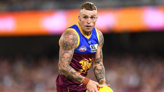 BRISBANE, AUSTRALIA – APRIL 14: Mitch Robinson of the Lions handles the ball during the round five AFL match between the Brisbane Lions and the Collingwood Magpies at The Gabba on April 14, 2022 in Brisbane, Australia. (Photo by Albert Perez/AFL Photos/Getty Images)