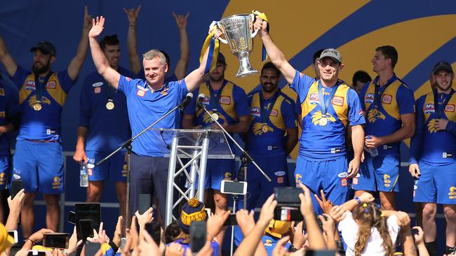 Scott Lycett, second from left, watches West Coast coach Adam Simpson and captain Shannon Hurn show the AFL Premiership Cup to fans after returning to Perth. Picture: Paul Kane/Getty Images