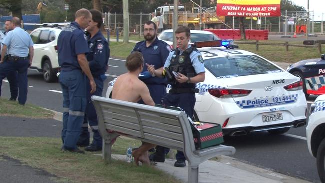 Police talk to a man at the scene of the brawl on Monday afternoon. Picture: TNV