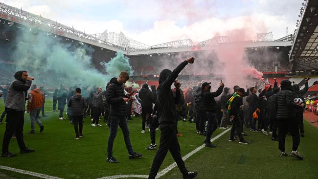 Supporters protest against Manchester United's owners, inside English Premier League club Manchester United's Old Trafford stadium in Manchester, north west England on May 2, 2021, ahead of their English Premier League fixture against Liverpool. - Manchester United were one of six Premier League teams to sign up to the breakaway European Super League tournament. But just 48 hours later the Super League collapsed as United and the rest of the English clubs pulled out. (Photo by Oli SCARFF / AFP)