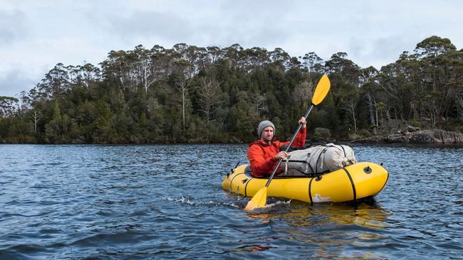 Walker and trout fisher Richard Webb leaves Halls Island on Lake Malbena in the Walls of Jerusalem National Park.