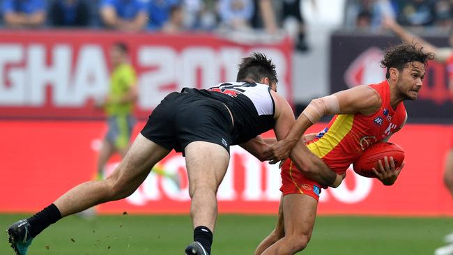 Charlie Dixon of the Power flies in an effort to tackle Gold Coast’s Jarrod Harbrow in Shanghai. Picture: AAP Image/David Mariuz                        <a capiid="e7f6cc128a409f740adc9e89c334ac70" class="capi-video">Port punish Suns in Shanghai</a>